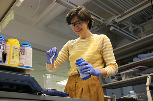 Pictured: Abby Chapin measuring silicone for adhesive wafer for ostomy bag